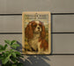 a framed illustration of a Cavalier King Charles Spaniel dog, which is mounted on a wall.