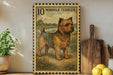a framed illustration of a Norfolk Terrier dog, which is a type of terrier breed. The dog is depicted in a pastoral setting, surrounded by grass and trees. The frame has a decorative border and the text "10 NORFOLK TERRITOR" is visible, indicating the dog's breed.