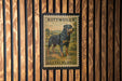 A vintage Rottweiler dog stamp from Germany, featuring a black and brown Rottweiler standing in a grassy field.
