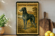 a framed illustration of a Scottish deerhound dog, with a wooden cutting board and a potted plant in the background.