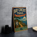 A vintage-style metal sign for the Bay Circuit Trail in Massachusetts, featuring a scenic illustration of a path leading to a sailboat on the water.