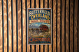 A vintage-style metal sign for the "Butterfield Overland Mail Route" in California, featuring a red coach traveling through the state.