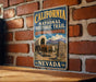 A vintage-style metal sign for the California National Historic Trail, featuring an illustration of a wagon and a sign for Nevada.