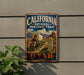 A vintage-style metal sign with the text "CALIFORNIA NATIONAL HISTORIC TRAIL UTAH" and an illustration of a wagon train on a trail.
