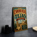 A vintage-style metal sign for "El Camino Real de los Tejas, Texas" is displayed on a gray countertop, accompanied by a stack of black camera lenses and a white dish.