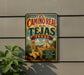 A vintage-style sign for "El Camino Real de los Tejas, Texas" is displayed on a wall, featuring a scenic illustration of a historic landmark.
