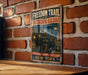 a vintage-style sign for the "Freedom Trail of the Underground Railroad" in New York, depicting a group of people on a path towards freedom.