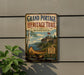 A vintage-style metal sign for the Grand Portage Heritage Trail in Minnesota, featuring a canoe and a scenic landscape.