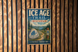A vintage metal sign for the Ice Age Trail in Wisconsin, featuring a scenic illustration of a trail surrounded by trees and mountains.