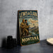 A vintage metal sign for the Lewis & Clark National Historic Trail in Montana, featuring two men on a mountain trail with a scenic backdrop.
