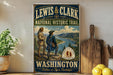 A vintage-style metal sign for the Lewis and Clark National Historic Trail in Washington, featuring two figures in historical attire standing on a cliff overlooking a river.