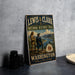 A vintage-style metal sign for the Lewis and Clark National Historic Trail, featuring a scenic illustration of two hikers on a mountain trail with a river and mountains in the background.