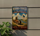 A vintage-style metal sign for the Mormon Pioneer National Historic Trail in Illinois, featuring an illustration of a covered wagon and a scenic landscape.