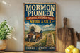 A vintage-style sign for the Mormon Pioneer National Historic Trail in Nebraska, featuring an illustration of a covered wagon and a monument with the words "Faith Family Freedom 1847".