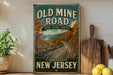 a vintage-style sign for the "Old Mine Road" in New Jersey, with a scenic road winding through a forested area.
