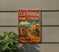 a vintage-style sign for the Old Spanish National Historic Trail in New Mexico, with a desert landscape and a bell tower visible.