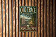 a vintage-style sign for the Old Trace Historic Path in Mississippi, mounted on a wooden wall.