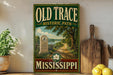 a vintage-style sign for the Old Trace Historic Path in Mississippi, with a scenic illustration of a path surrounded by trees and a body of water.