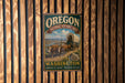 A vintage-style metal sign for the Oregon National Historic Trail, featuring an illustration of a covered wagon and a scenic landscape.