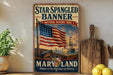 a vintage-style metal sign with an American flag and a ship, displayed on a shelf next to a wooden cutting board and some lemons.