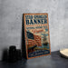 a vintage-style metal sign with an American flag and a ship, placed on a gray surface next to some black camera lenses.