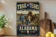 A vintage-style sign for the Trail of Tears, featuring a wagon train traveling through a rural landscape, with the text "Trail of Tears" and "National Historic Trail" prominently displayed.