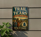 A vintage trail sign for the Trail of Tears, which is a National Historic Trail in Tennessee. The sign features a historical illustration of a group of people traveling on a wagon train.