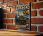 a vintage-style sign with the text "Underground Railroad Network & Freedom Trail" and "OHIO" on it, mounted on a brick wall.