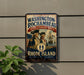 A vintage-style metal sign with the text "WASHINGTON-ROCCHAMBEAU REVOLUTIONARY ROUTE" and "RHODE ISLAND" is displayed on a wall, with a plant in the foreground.