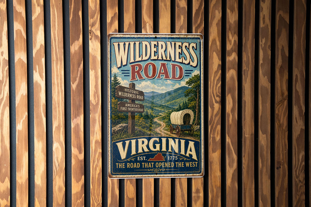 A vintage-style metal sign for Wilderness Road in Virginia, featuring a wagon train and a scenic mountain landscape.