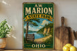 A vintage-style sign for A.W. Marion State Park in Ohio, featuring a scenic landscape with a lake and forest.