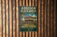 A vintage-style metal sign for Addison Blockhouse Historic State Park in Florida, featuring a wooden cabin and palm trees.