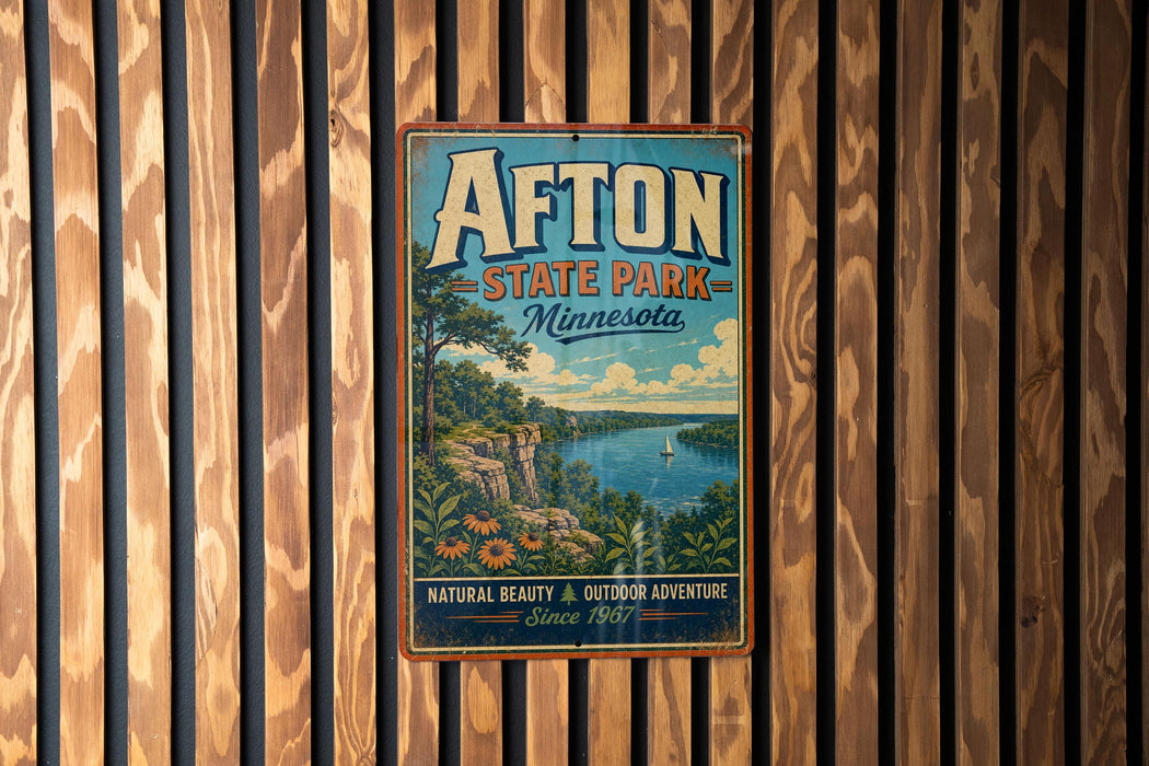 A vintage-style metal sign for Afton State Park in Minnesota, featuring a scenic landscape with a lake, mountains, and a sailboat.