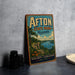A vintage-style sign for Afton State Park in Minnesota, featuring a scenic landscape with a lake, mountains, and a sailboat.