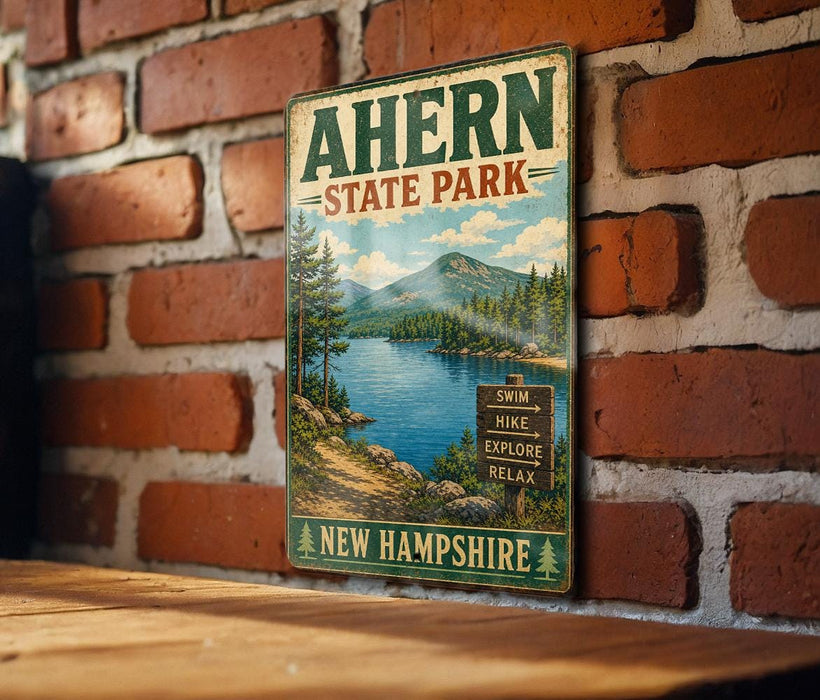 A vintage metal sign for Ahern State Park in New Hampshire, featuring a scenic mountain landscape with a lake and pine trees.