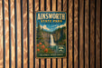 A vintage metal sign for Ainsworth State Park in Oregon, featuring a waterfall and forest scenery.