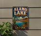 A vintage-style sign for Alamo Lake State Park in Arizona, featuring a desert landscape with a cactus and a lake.