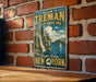 A vintage-style metal sign for Allan H. Treman State Marine Park, featuring a scenic image of a waterfall and a sailboat on Finger Lakes, New York.