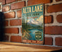 A vintage metal sign for Alta Lake State Park in Washington, featuring a scenic mountain landscape and inviting visitors to explore nature.
