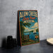 A vintage-style metal sign for Alum Creek State Park in Ohio, featuring a scenic illustration of a lake with a sailboat, surrounded by trees and mountains.