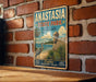 A vintage-style metal sign for Anastasia State Park in Florida, featuring a beach scene with palm trees and a lighthouse, mounted on a brick wall.