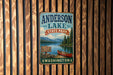 A vintage-style metal sign for Anderson Lake State Park in Washington, featuring a scenic image of a lake, mountains, and a red canoe.