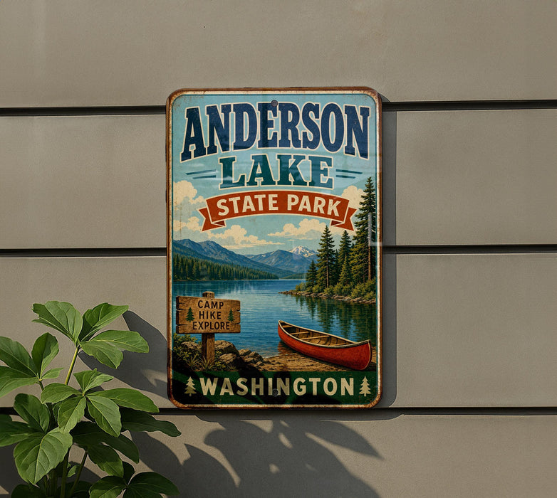 A vintage-style metal sign for Anderson Lake State Park, featuring a scenic image of a lake, mountains, and a canoe, mounted on a wall.