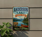 A vintage-style metal sign for Anderson Lake State Park, featuring a scenic image of a lake, mountains, and a canoe, mounted on a wall.