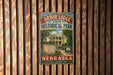 A vintage-style metal sign for Arbor Lodge State Historical Park in Nebraska, featuring an illustration of a lodge surrounded by trees and a sign that reads "Established 1971".