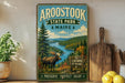 A vintage-style metal sign for Aroostook State Park in Maine, featuring a moose in a forest landscape.