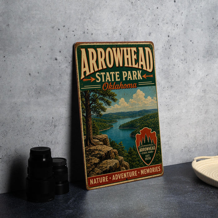 A vintage-style metal sign for Arrowhead State Park in Oklahoma, featuring a scenic landscape with a river and mountains.