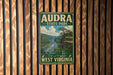 A vintage metal sign for Audra State Park in West Virginia, featuring a scenic image of a river and mountains.