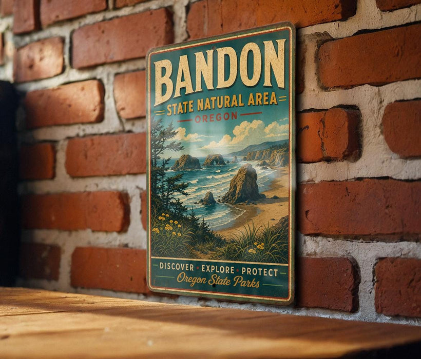 A vintage-style metal sign for Bandon State Natural Area in Oregon, featuring a scenic landscape with rocky cliffs, a beach, and a forest.