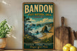 A vintage-style poster of Bandon State Natural Area in Oregon, featuring a scenic coastal landscape with rocky cliffs, a beach, and a pine tree.